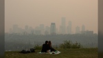 Last year’s record-breaking wildfire season forced Canadians to become familiar with the scale of air pollution as hazardous smoke drifted across the country. Smoke from wildfires blankets the city as a couple has a picnic in Edmonton, Saturday, May 11, 2024. THE CANADIAN PRESS/Jason Franson