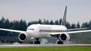 A Singapore Airlines Boeing 777-312ER readies to take off from Paine Field Tuesday, Sept. 17, 2013, in Everett, Wash. Singapore Airlines said on Tuesday, May 21, 2024, a person died aboard and others were injured when a London-Singapore flight encountered severe turbulence. (AP Photo/Elaine Thompson)