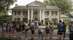 Fans wait in line outside Graceland Tuesday, Aug. 15, 2017, in Memphis, Tenn. The granddaughter of Elvis Presley is fighting plans to publicly auction his Graceland estate in Memphis after a company tried to sell the property based on claims that a loan using the king of rock ’n’ roll's former home as collateral was not repaid. (AP Photo/Brandon Dill, File)