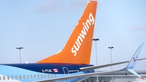 A Sunwing aircraft is parked at Montreal Trudeau Airport in Montreal on Wednesday, March 2, 2022. THE CANADIAN PRESS/Paul Chiasson