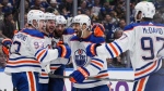 Edmonton Oilers' Ryan Nugent-Hopkins, from left to right, Zach Hyman, Leon Draisaitl, Evan Bouchard and Connor McDavid celebrate Nugent-Hopkins' goal during the second period in Game 7 of an NHL hockey Stanley Cup second-round playoff series, in Vancouver, on Monday, May 20, 2024. THE CANADIAN PRESS/Darryl Dyck