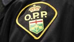 An Ontario Provincial Police logo is seen on an officer during a press conference, in Barrie, Ont., Wednesday, April 3, 2019. THE CANADIAN PRESS/Nathan Denette