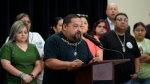 Javier Cazares, center, stands with families of the victims in the Uvalde elementary school shooting during a news conference, Wednesday, May 22, 2024, in Uvalde, Texas. (AP Photo/Eric Gay)