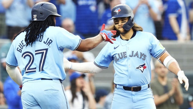 Toronto Blue Jays' Bo Bichette, right, celebrates his two-run home run against the Chicago White Sox with Vladimir Guerrero Jr. (27) during second inning MLB baseball action in Toronto on Wednesday, May 22, 2024. THE CANADIAN PRESS/Frank Gunn