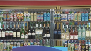 Alcoholic beverages are pictured in refrigerators. 