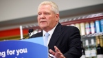 Ontario Premier Doug Ford makes an announcement at a gas station saying the province is speeding up the expansion of alcohol sales, in Toronto on Friday, May 24, 2024. THE CANADIAN PRESS/Christopher Katsarov 