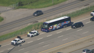 A bus with a shattered windshield is seen on the side of the QEW in St. Catharines following a collision on Friday, May 24, 2024. (Chopper 24)