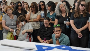 Mourners attend the funeral of Michel Nisenbaum, who was killed during Hamas' Oct. 7 attack and whose body was taken into Gaza, in Ashkelon, Israel, on Sunday, May 26, 2024. (AP Photo/Tsafrir Abayov)