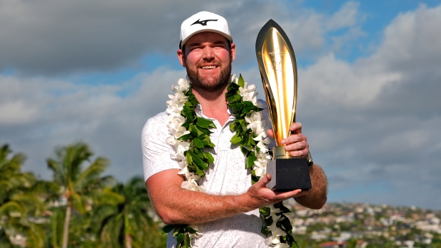 Grayson Murray holds the trophy after winning the Sony Open golf event, Sunday, Jan. 14, 2024, at Waialae Country Club in Honolulu. (AP Photo/Matt York, File)