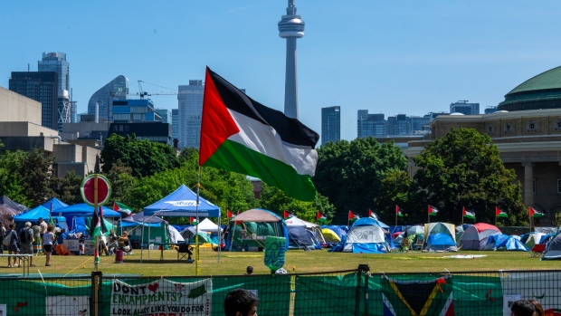 A Palestinian flag flies over the pro-Palestinian encampment set up at the University of Toronto campus in Toronto on Sunday, May 26, 2024. Pro-Palestinian protesters who have been camped out at the University of Toronto for weeks say they have no plans to honour the terms of a trespass notice issued by the school and clear the demonstration site by 8 a.m. THE CANADIAN PRESS/Frank Gunn
