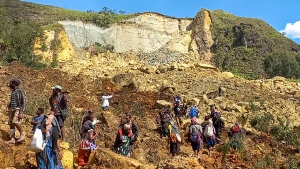 Villagers search through a landslide in Yambali village in the Highlands of Papua New Guinea, Sunday, May 26, 2024. (Kafuri Yaro/UNDP Papua New Guinea via AP)
