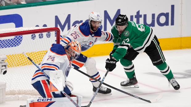 Edmonton Oilers goaltender Stuart Skinner (74) blocks a shot by Dallas Stars right wing Evgenii Dadonov (63) with help from teammate Darnell Nurse (25) during the third period in Game 2 of the Western Conference finals in the NHL hockey Stanley Cup playoffs Saturday, May 25, 2024, in Dallas. (AP Photo/Tony Gutierrez)
