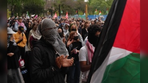 People attend a rally outside Convocation Hall on the University of Toronto campus on Monday, May 27, 2024. The University of Toronto says it's taking legal action in an effort to clear an encampment of pro-Palestinian protesters from its downtown campus. THE CANADIAN PRESS/Chris Young