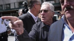 Robert De Niro, center, argues with a Donald Trump supporter after speaking to reporters in support of President Joe Biden across the street from Trump's criminal trial in New York, Tuesday, May 28, 2024. (AP Photo/Seth Wenig)