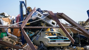 Vehicles are tangled in the debris of a collapsed body shop on May 26, 2024 after a tornado rolled through Valley View, Texas. (Julio Cortez /AP via CNN Newsource)