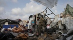 Displaced Palestinians inspect their tents destroyed by Israel's bombardment, adjunct to an UNRWA facility west of Rafah city, Gaza Strip, May 28, 2024. (AP Photo/Jehad Alshrafi)