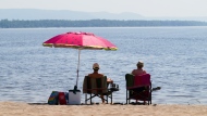 People take to the waters and shores of the Ottawa River in the Ottawa suburb of Constance Bay on Tuesday, July 6, 2023. The Weather Network is predicting more sunshine and warmer temperatures for the summer. THE CANADIAN PRESS/Sean Kilpatrick