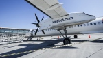 A WestJet Encore Bombardier Q400 twin-engined turboprop aircraft is prepared for a flight in Kamloops, Saturday, June 3, 2023. Pilots at WestJet's regional carrier could be going on strike at the beginning of June. THE CANADIAN PRESS/Jeff McIntosh