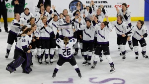 Minnesota captain Kendall Coyne Schofield (26) takes the trophy to her team after defeating Boston to win the PWHL Walter Cup, Wednesday May 29, 2024, in Lowell, Mass. (AP Photo/Mary Schwalm) 