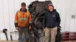 Barry Sawchuk (left) and Samantha Lawler, an associate professor of astronomy at the University of Regina, pose near a piece of space debris found on his farm in February. THE CANADIAN PRESS/HO-University of Regina- Samantha Lawler