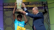 Bruhat Soma, 12, of Tampa, Fla., holds the trophy after winning the Scripps National Spelling Bee, in Oxon Hill, Md., Thursday, May 30, 2024. (AP Photo/Jacquelyn Martin) 