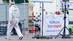 A forensic police officer walks past a smashed stall which had a banner with writing reading 'Stop political Islam,' on the market square in Mannheim, Germany, Friday, May 31, 2024. (Uwe Anspach/dpa via AP)