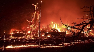 A home burns during the Corral Fire at Bernard and Stearman roads, west of Tracy, Calif., Saturday, June 1, 2024. (Kent Porter/The Press Democrat via AP)