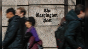FILE - People walk by the One Franklin Square Building, home of The Washington Post newspaper, in downtown Washington, Feb. 21, 2019. The struggling Washington Post was in some turmoil on Monday, June 3, 2024, following a hastily announced restructuring plan aimed at stopping an exodus of readers over the past few years, and the departure of the newspaper's executive editor, Sally Buzbee. (AP Photo/Pablo Martinez Monsivais, File)