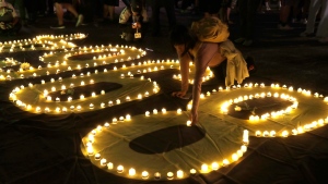 Participants attend a candlelight vigil at Democracy Square in Taipei, Taiwan, Tuesday, June 4, 2024, to mark the 35th anniversary of the Chinese military crackdown on the pro-democracy movement in Beijing's Tiananmen Square. (AP Photo/Chiang Ying-ying) 