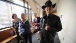 FILE - Timothy Hoffman, right, father of slain teenager Cynthia Hoffman receives support from Edie Grunwald, left, as they enter a Superior courtroom for the arraignment of Cynthia's murder suspects in the Nesbett Courthouse on June 18, 2019, in Anchorage, Alaska. (Bill Roth/Anchorage Daily News via AP, File)/