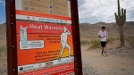 A hiker finishes his morning walk at the South Mountain Preserve to beat the high temperatures, Thursday, July 11, 2019, in Phoenix. An excessive heat warning is in effect for the Phoenix area with temperatures expected to hit 113. (AP Photo/Matt York)