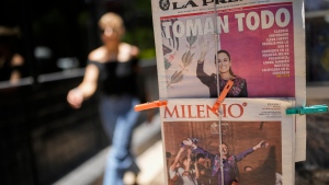 Mexican newspapers show photos of presidential candidate Claudia Sheinbaum declaring victory in Mexico City, Monday, June 3, 2024, the day after the general election. (AP Photo/Matias Delacroix)