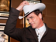 Actor Paul Gross, puts on the White Hat he was presented with by Calgary Mayor Dave Bronconnier, before the premiere of Gross' move "Gunless" in Calgary, Tuesday, April 20, 2010. Gunless opens in theatres April 30.(THE CANADIAN PRESS/Jeff McIntosh)