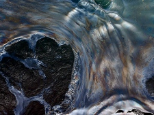 Oily water is seen off the side of the Joe Griffin supply vessel at the site of the Deepwater Horizon oil spill containment efforts in the Gulf of Mexico off the coast of Louisiana Saturday, May 8, 2010. (AP Photo/Gerald Herbert)