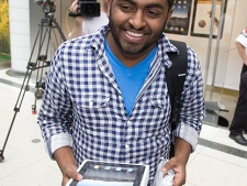 Eighteen-year-old Delaan Ruban leaves an Apple store in Toronto after being the first in line to purchase an iPad Friday, May 28, 2010. (THE CANADIAN PRESS/Darren Calabrese)