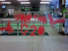 A bank's window is damaged after vandals spray-painted anti G20 slogans. (CP24/Mathew Reid)