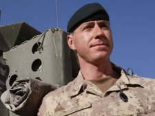 Brig. Gen. Daniel Menard, commander of Canada's Task Force Afghanistan, stands by a Light Armored Vehicle (LAV) in Kandahar Province, southern Afghanistan, Saturday, Jan. 30, 2010. (AP Photo/Kirsty Wigglesworth)