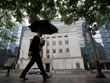 A pedestrian walks past the Bank of Canada in Ottawa, Canada Tuesday June 1, 2010. The Bank raised its key interest rate to 0.5 per cent. (THE CANADIAN PRESS/Adrian Wyld)