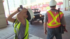 City staff examine cement underneath the Gardiner Expressway.