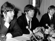 In this Aug. 11, 1966 file photo, John Lennon of the Beatles, center, is flanked by bandmates George Harrison, left, and Ringo Starr as he apologizes for his remark that "the Beatles are more popular than Jesus," at a Chicago news conference.(AP Photo)