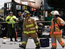 Police and firefighters work at the scene after a bomb exploded in Bogota, Colombia, Tuesday, May 15, 2012. (AP Photo/Ricardo Mazalan)