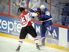 Canada's Marc Methot, left, and France's Yorick Treille in action during their Ice Hockey World Championship match in Helsinki, Finland Monday May 7, 2012. (AP Photo/Lehtikuva, Antti Aimo-Koivisto)