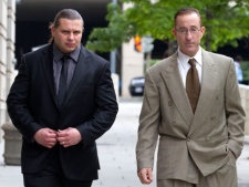 Brian McNamee, former trainer of former Major League baseball pitcher Roger Clemens, right, arrives at federal court in Washington, Wednesday, May 16, 2012, for Clemens' perjury trial. (AP Photo/Jacquelyn Martin)