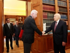 Panagiotis Pikramenos, the newly appointed caretaker prime minister of Greece, left, shakes hands with President Karolos Papoulias ahead of their meeting at the presidential palace in Athens on Wednesday, May 16, 2012. (AP Photo/John Kolesidis, Pool)