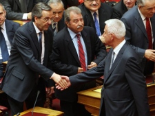 New Prime Minister Panagiotis Pikramenos, right, shakes hands with Conservatives New Democracy party leader Antonis Samaras during a swearing-in ceremony at the Greek parliament in Athens, Thursday, May 17, 2012. (AP Photo/Thanassis Stavrakis)