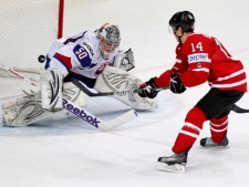 Slovakia's Jan Laco makes a save as Canada's Jordan Eberle attacks during their IIHF Ice Hockey World Championships quarterfinal match at the Hartwall Arena in Helsinki, Finland, Thursday, May 17, 2012. (AP Photo/Dmitry Lovetsky)