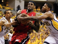 Miami Heat's LeBron James, center, goes to the basket against Indiana Pacers' George Hill (3) and Paul George, right, during the first half of Game 3 of their NBA basketball Eastern Conference semifinal playoff series on Thursday, May 17, 2012, in Indianapolis. (AP Photo/Darron Cummings)