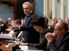 Quebec Premier Jean Charest responds to Oppositoin questions on an expected emergency law on tuition hikes as Education Minister Michelle Courchesne, centre, and Canadian Intergovernmental Affairs Minister Yvon Vallierres sit by his side during question period Thursday, May 17, 2012 at the legislature in Quebec City. THE CANADIAN PRESS/Jacques Boissinot