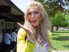 Transgender beauty queen Jenna Talackova gestures as Miss Universe Canada contestants visit St. John Vianney Catholic School in Toronto on Tuesday, May 15, 2012. (THE CANADIAN PRESS/Chris Young)