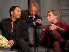 In this image released by Lionsgate, from left, Lenny Kravitz portrays Cinna, Woody Harrelson portrays Haymitch Abernathy and Josh Hutcherson portrays Peeta Mellark in a scene from "The Hunger Games." (AP Photo/Lionsgate, Murray Close)